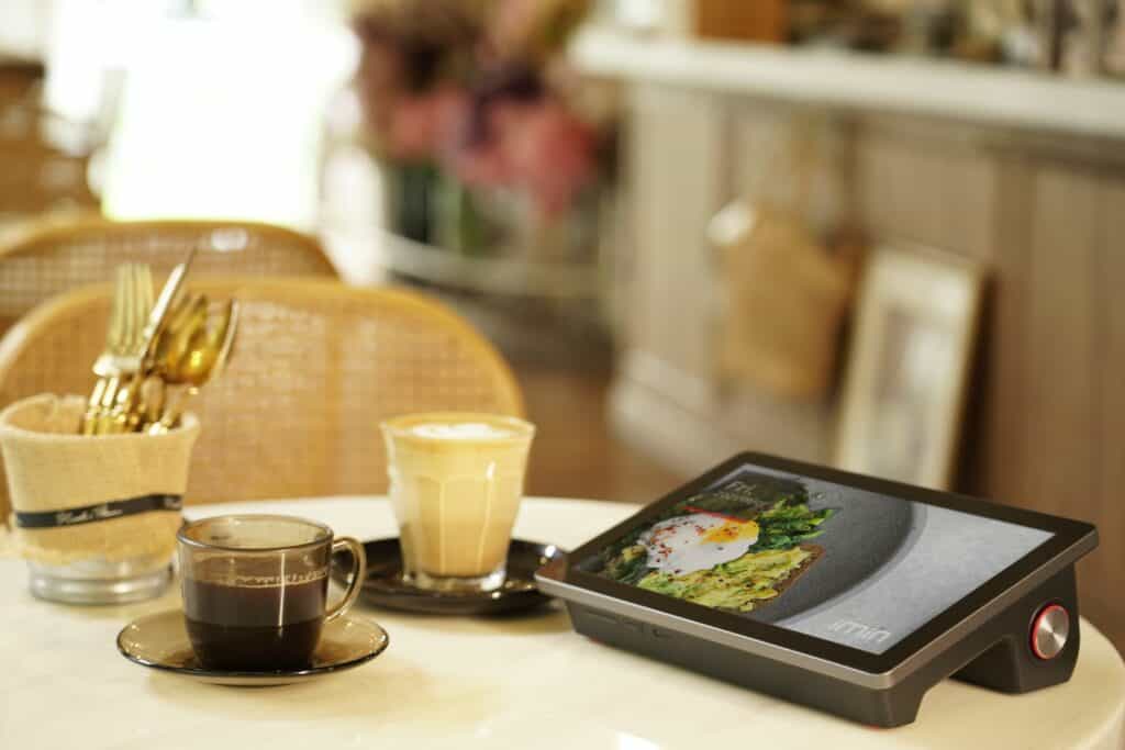 a tablet and coffee cups on a table