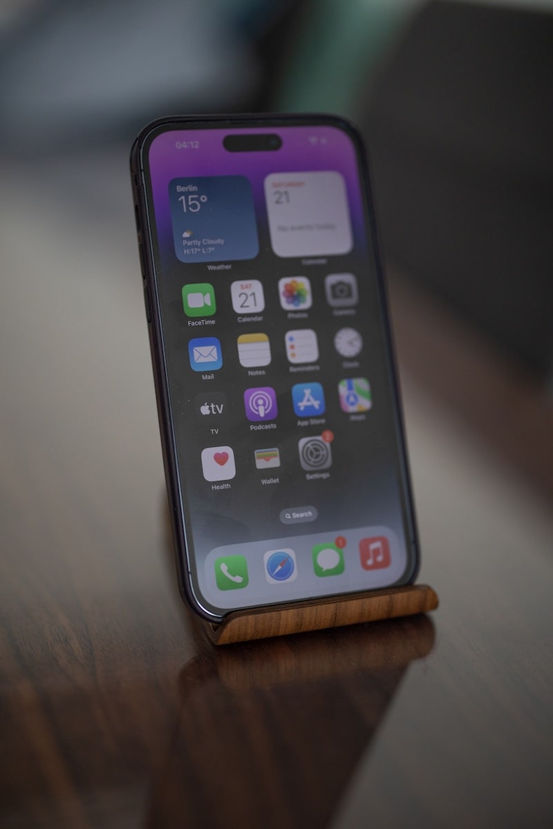 a cell phone sitting on top of a wooden table