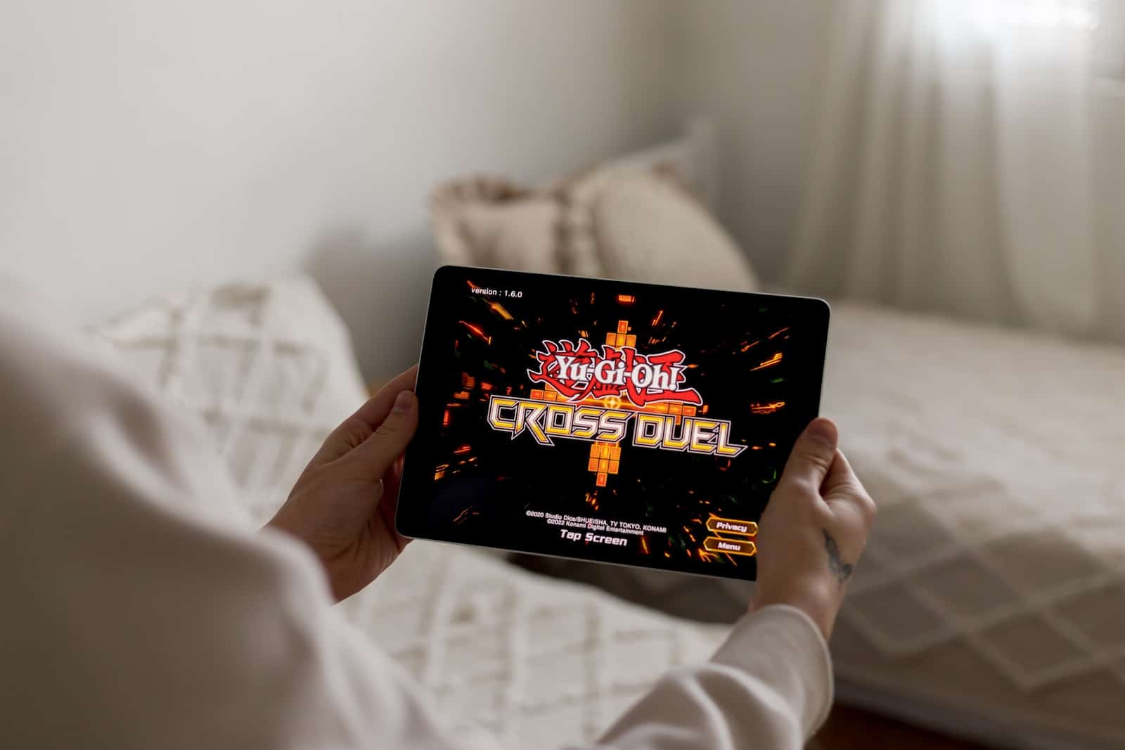 a person holding a tablet with a video game on it