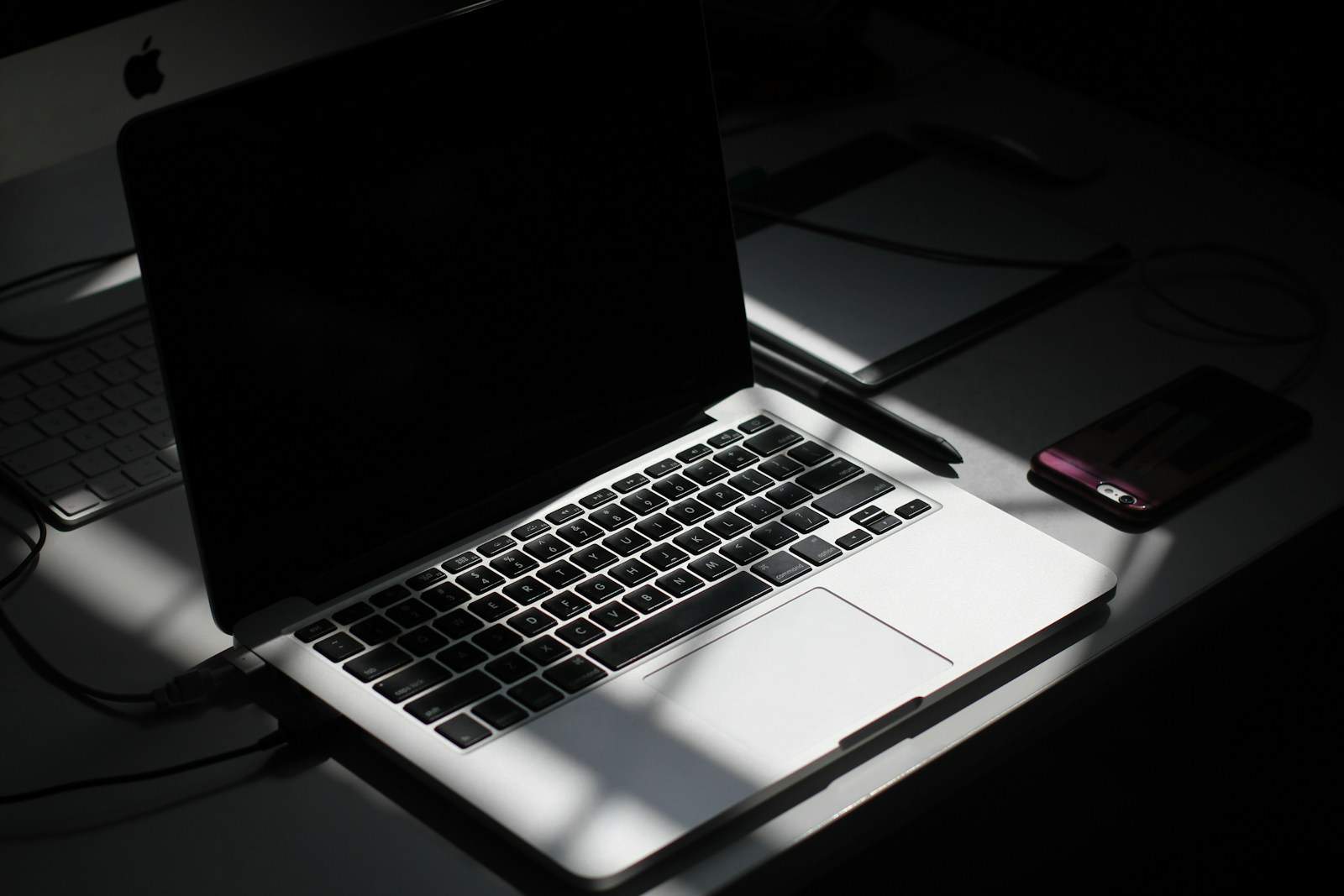 black and silver laptop computer beside smartphone