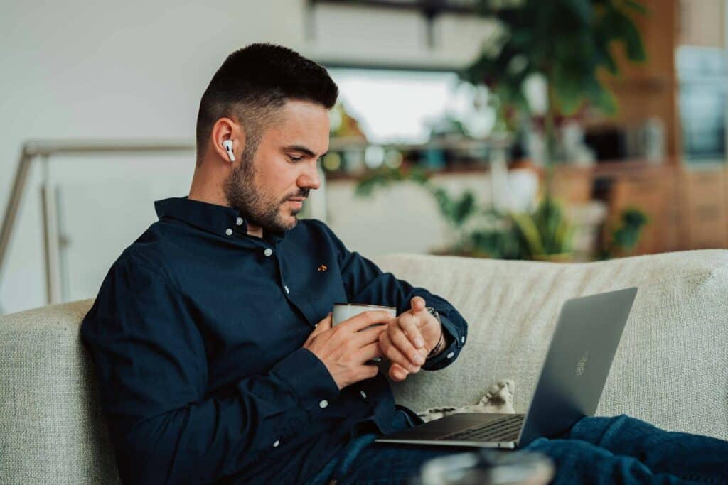 Man with Airpods and Macbook