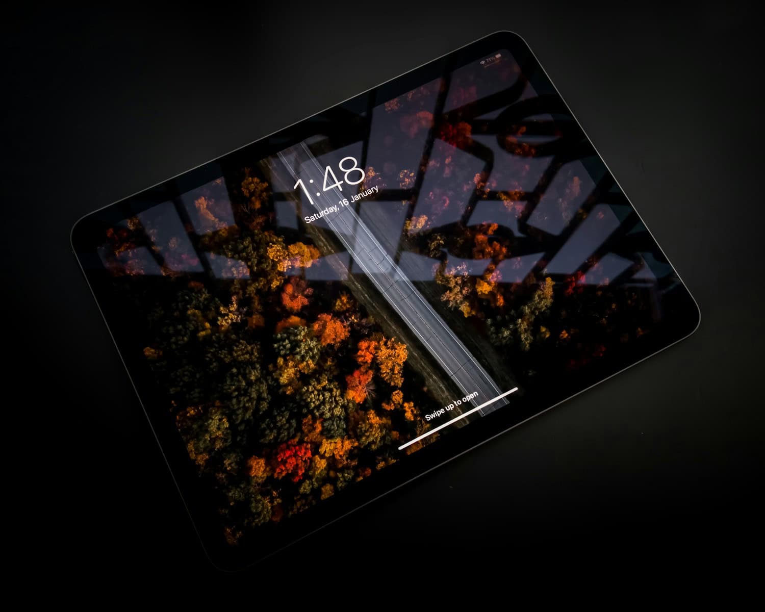 black ipad on black table